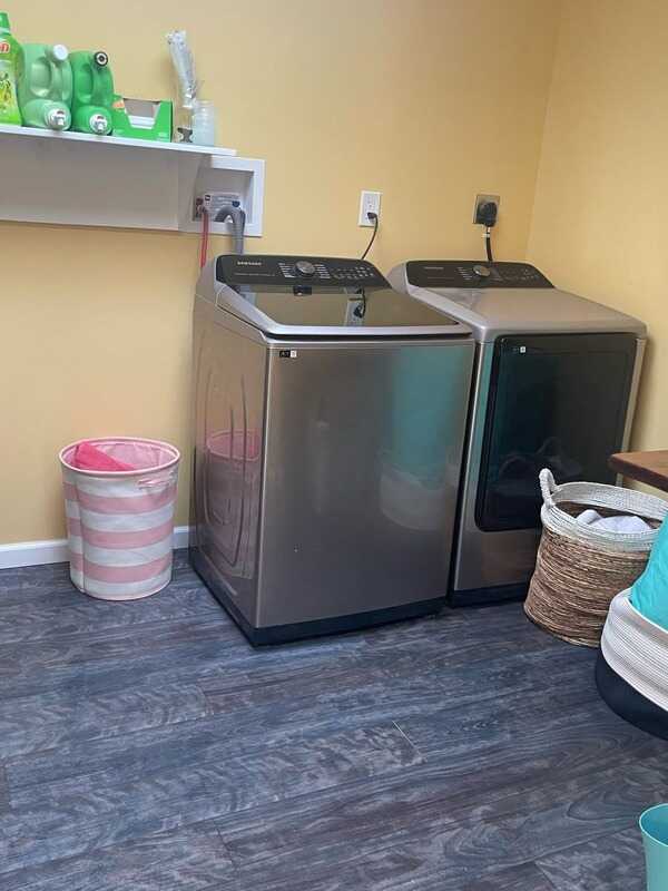 The same laundry room with the floor cleared and baskets put away